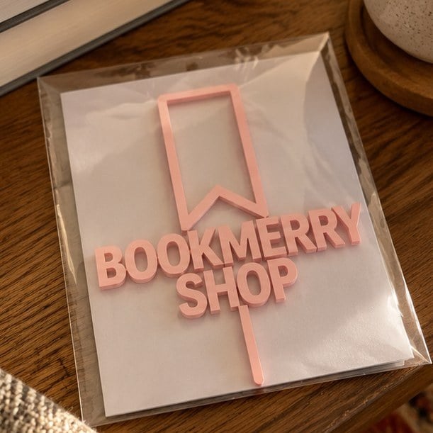 Customer photo of a custom acrylic cake topper in its sleeve